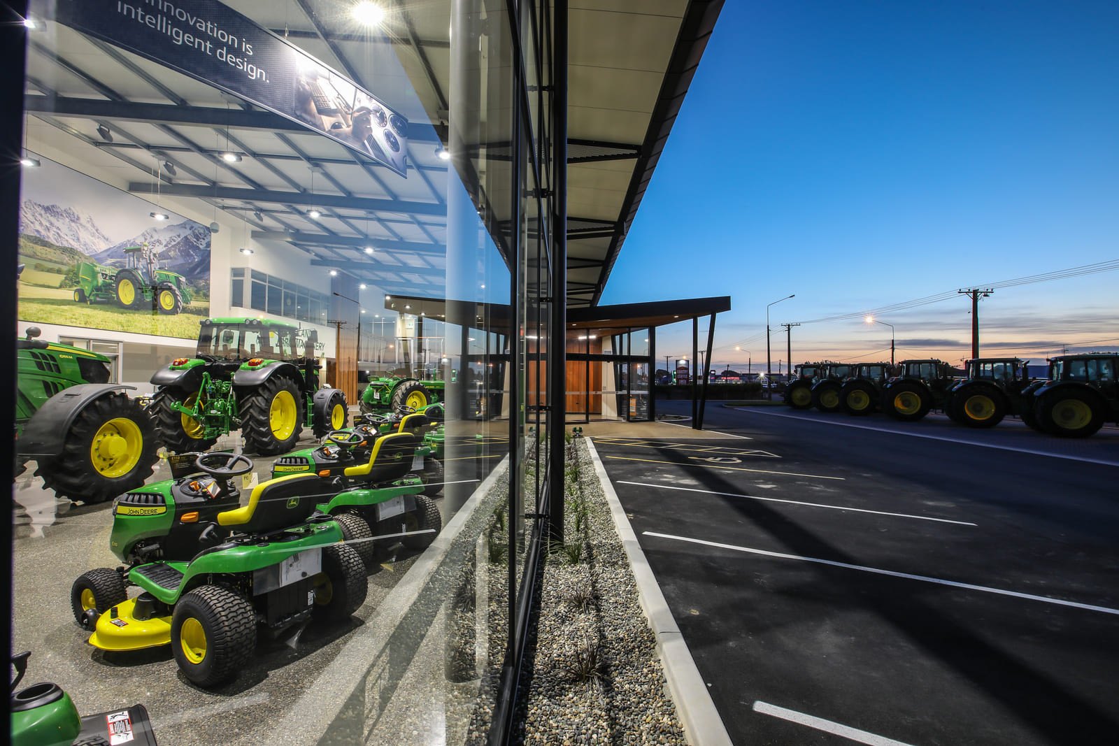 Tractors on display in a well-lit room with big windows