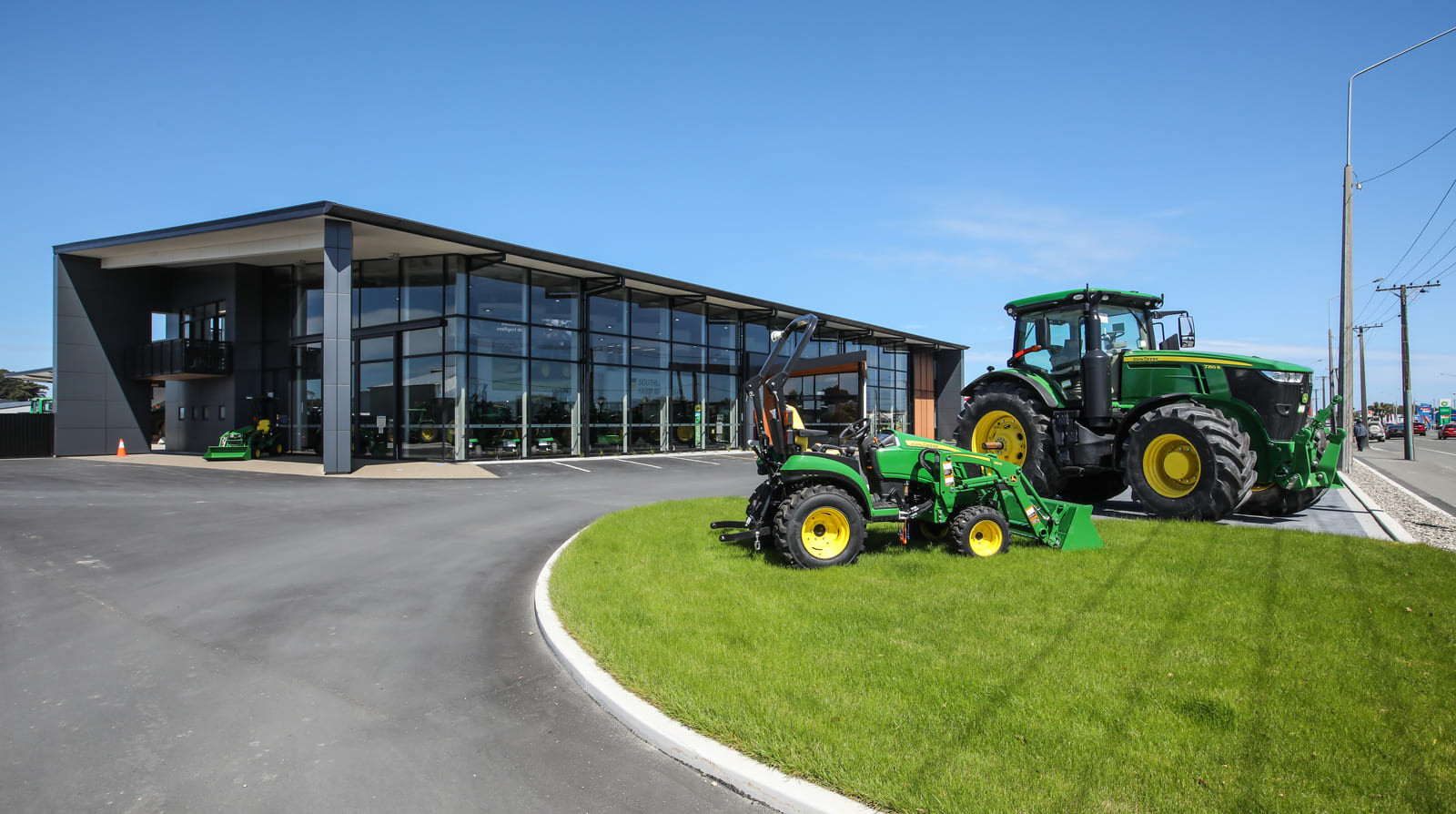 Clear glass windows showing blue sky and tractors  outside