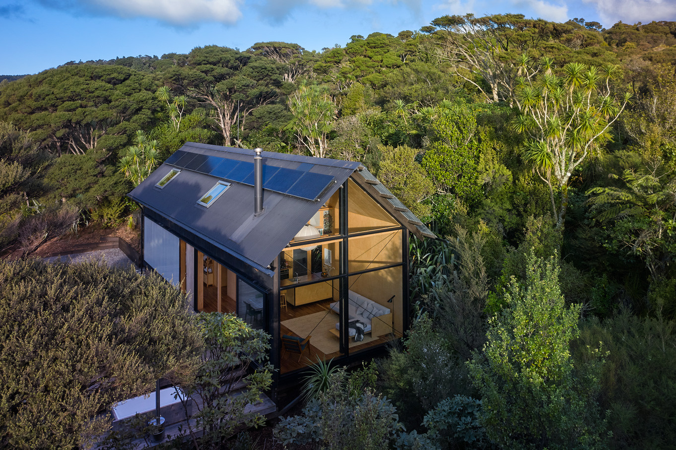 Cosy house nestled in bush with glass window