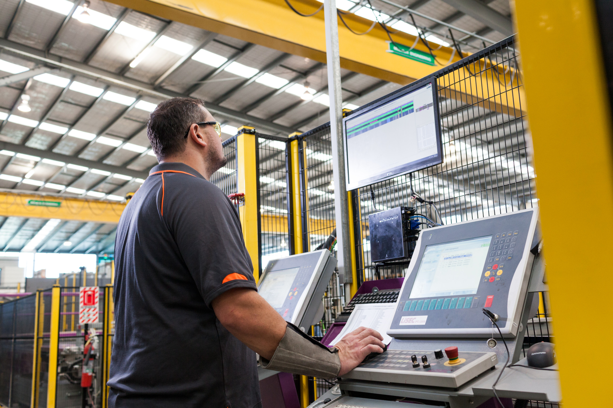 Man's hand touching screen of machine