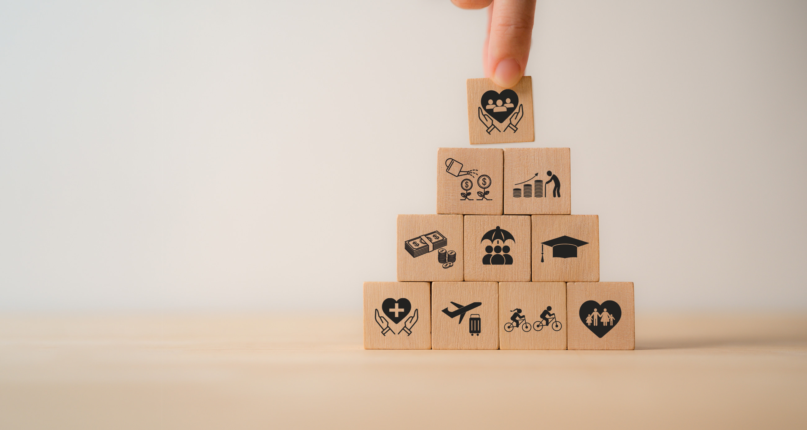 A person touching wooden blocks with icons on them.