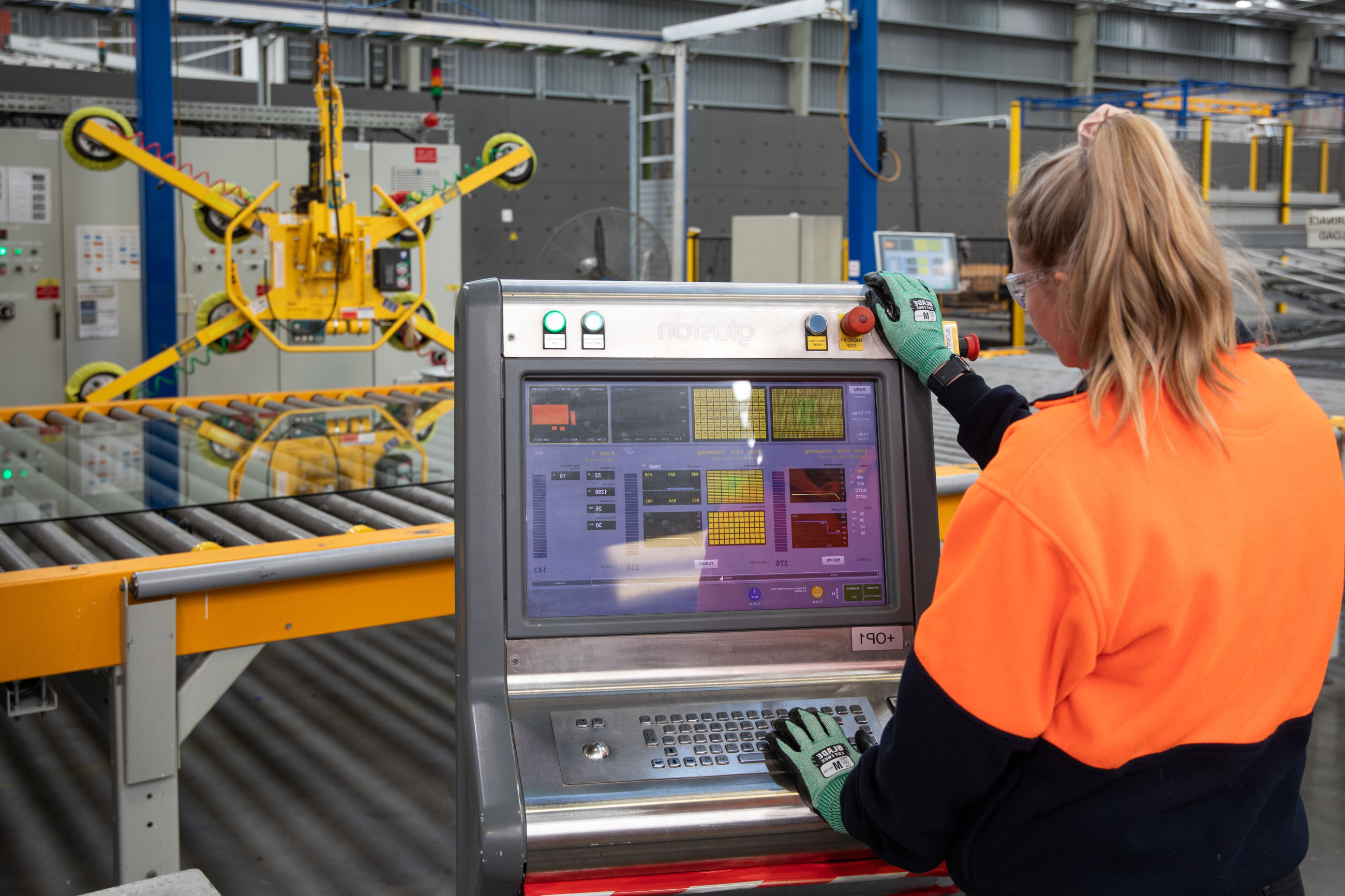 Women measuring glass with machine