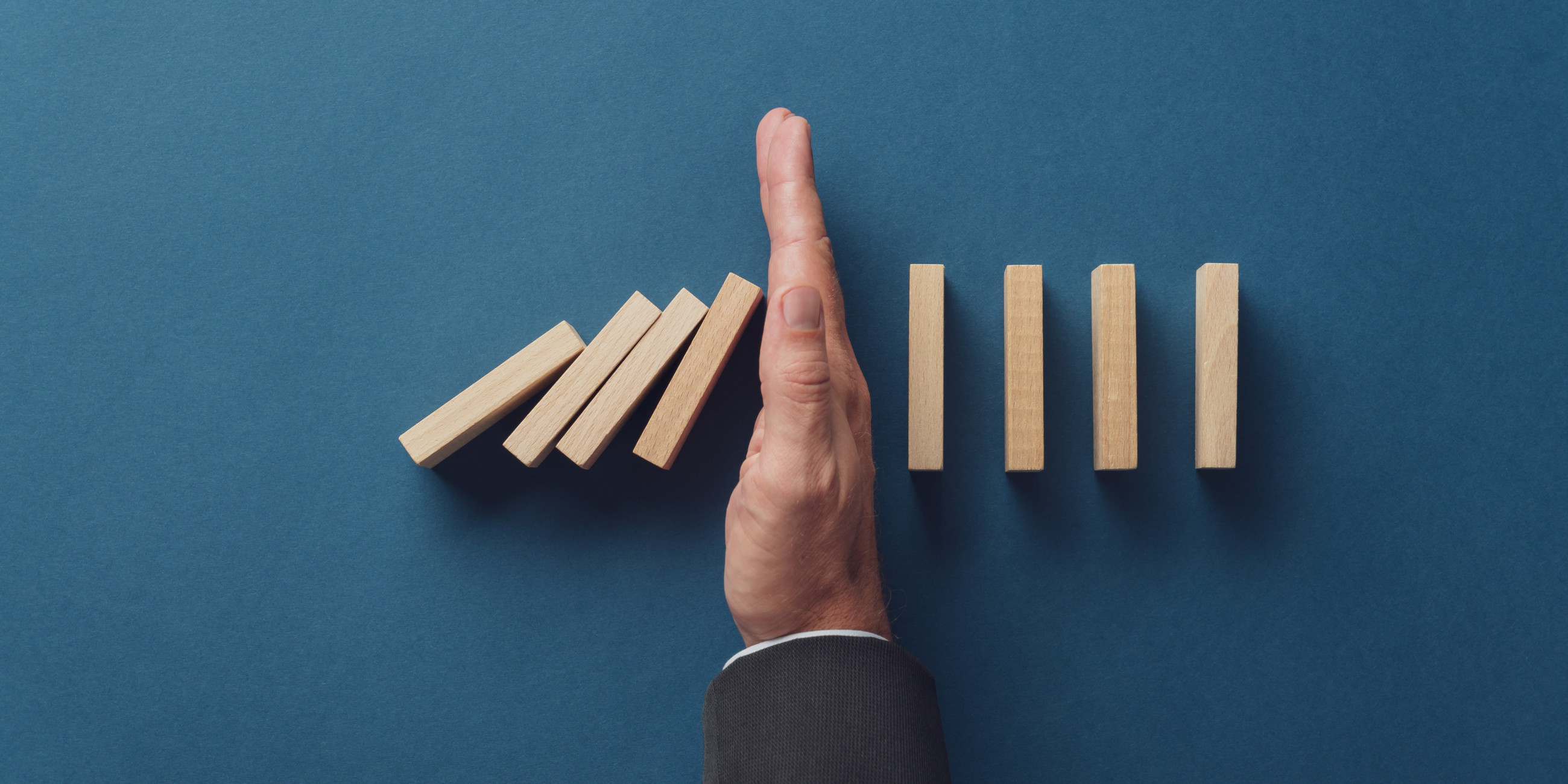 Blue background with hand and  blocks